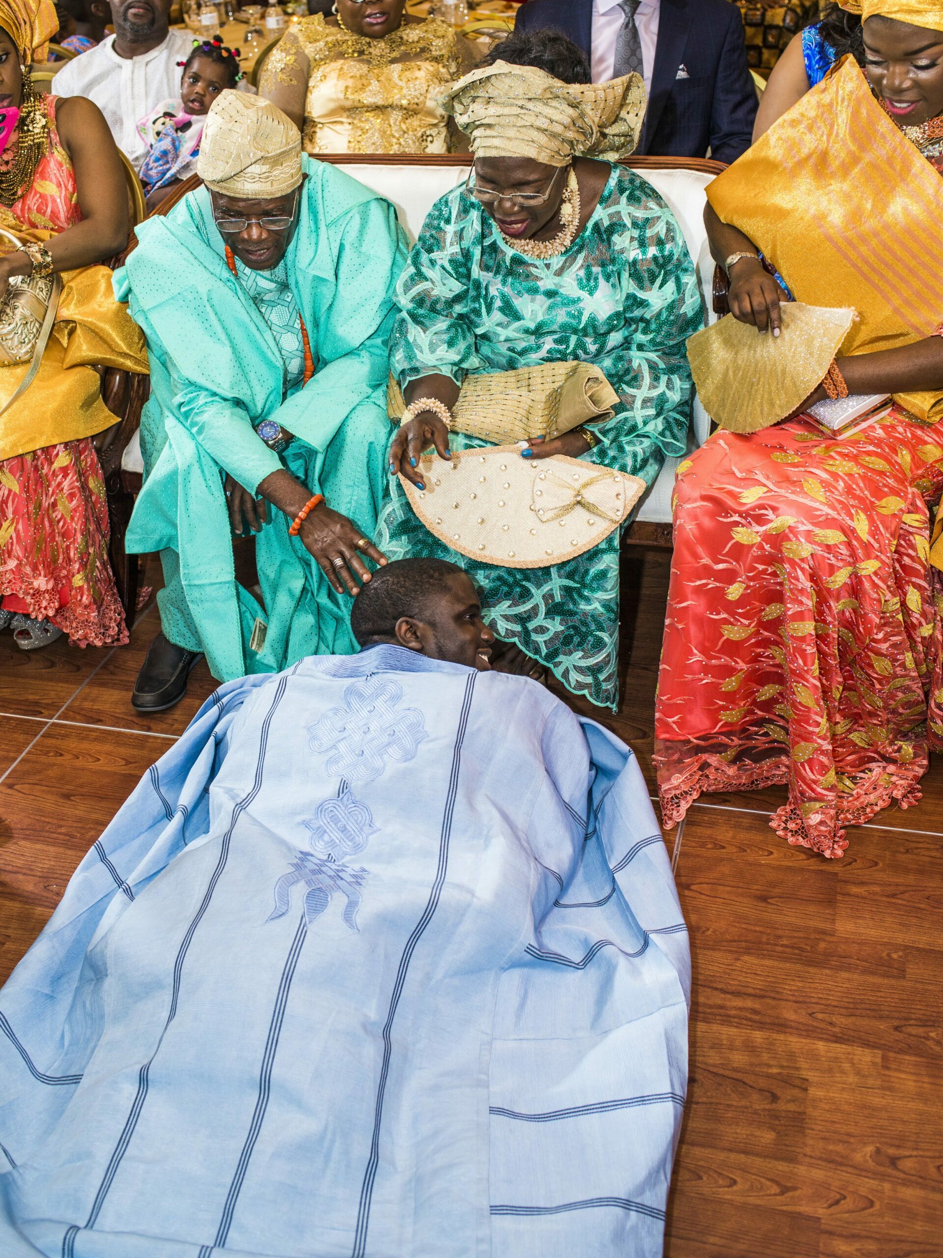 Nigerian Wedding Traditions Groom Prostrates to the Brides Parents